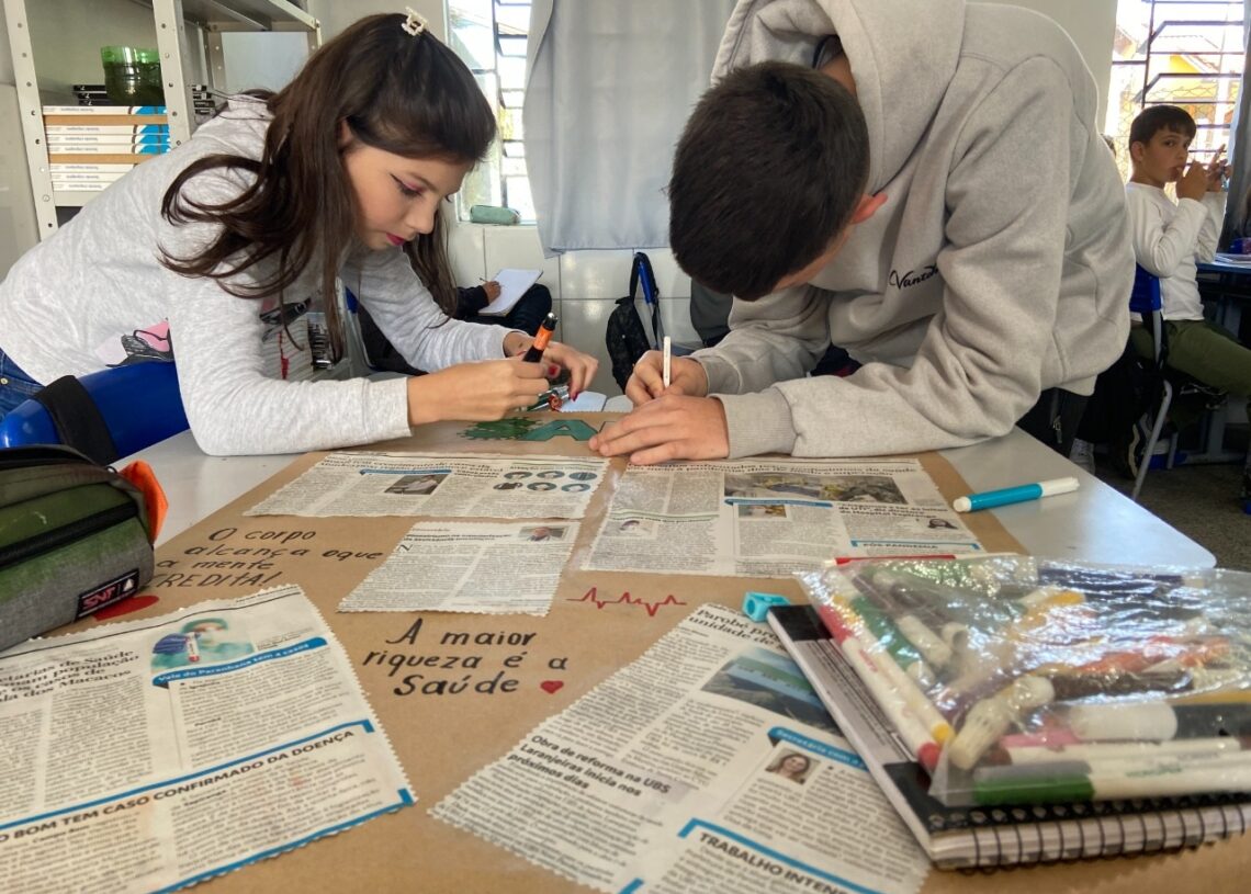 Estudantes confeccionando cartazes com reportagens sobre saúde 
(Fotos: Melissa Costa)